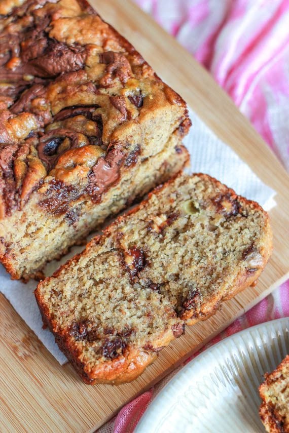 loaf of Nutella swirl peanut butter banana bread on a wood board