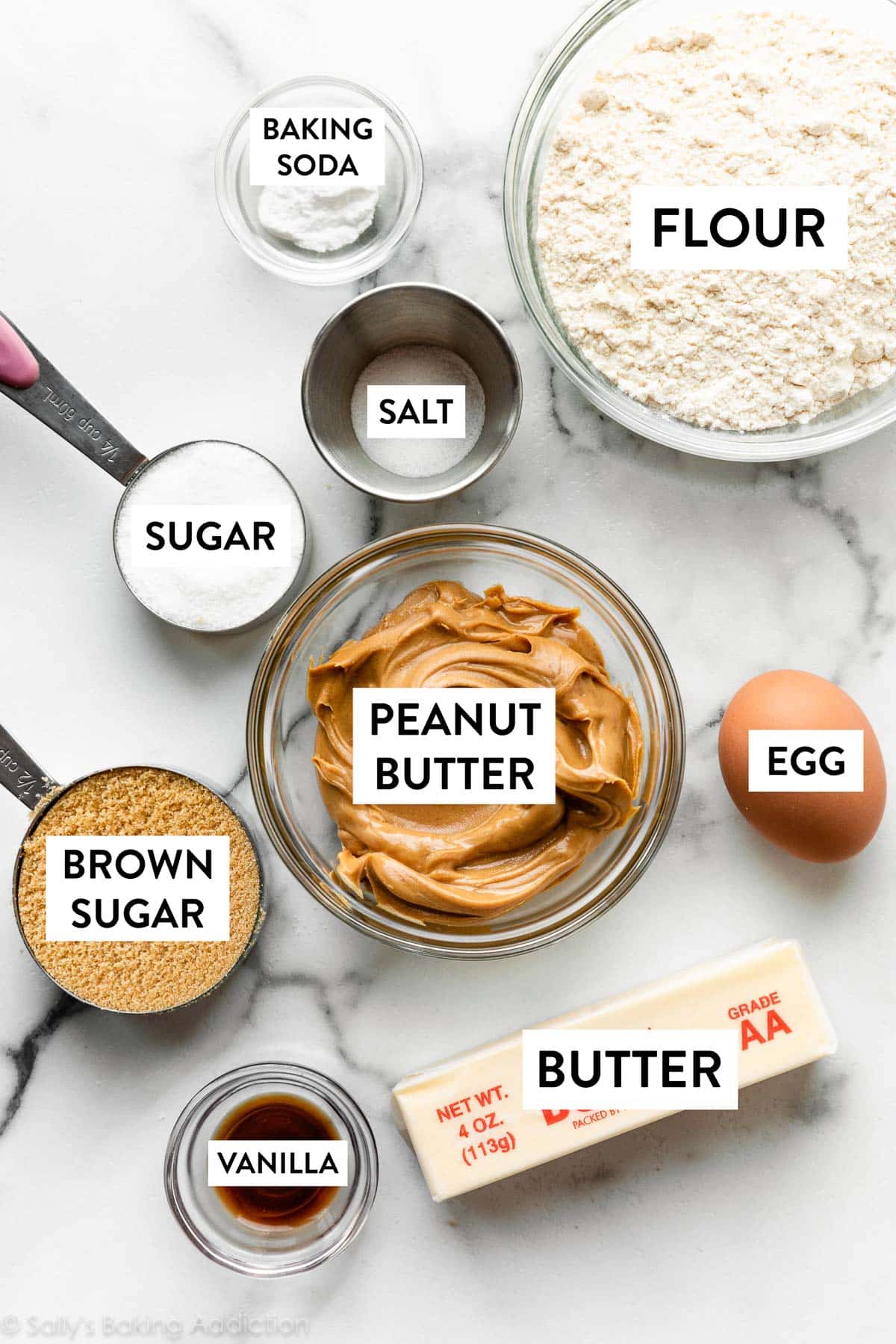 vanilla, egg, flour, butter, brown sugar, and other ingredients on marble counter