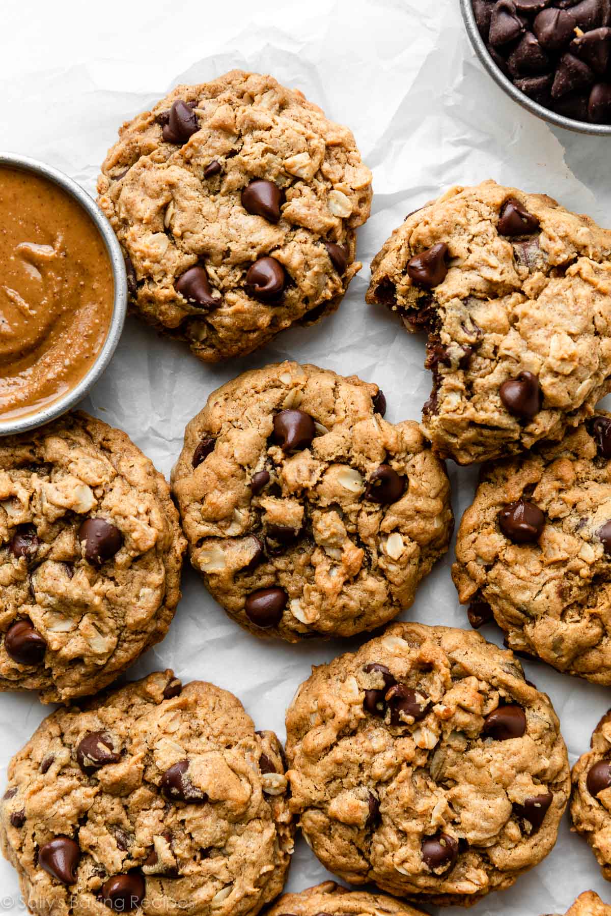 7 flourless peanut butter oatmeal cookies on white parchment paper.