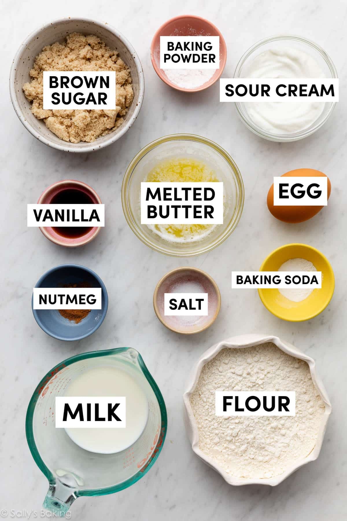 ingredients in bowls including milk, flour, baking soda, melted butter, sour cream, and brown sugar.