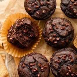 chocolate pumpkin muffins on parchment paper.
