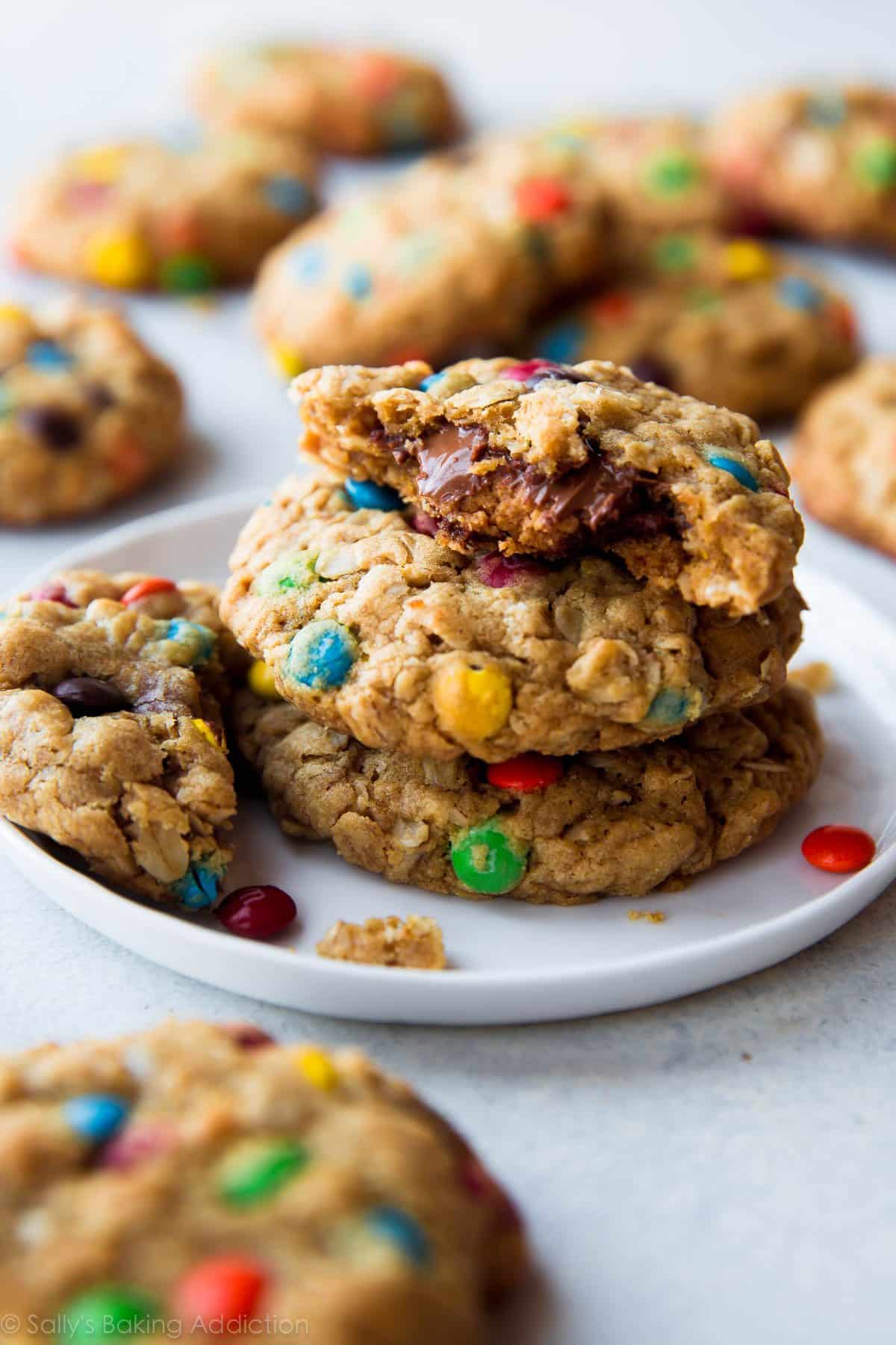 stack of peanut butter cup monster cookies on a white plate