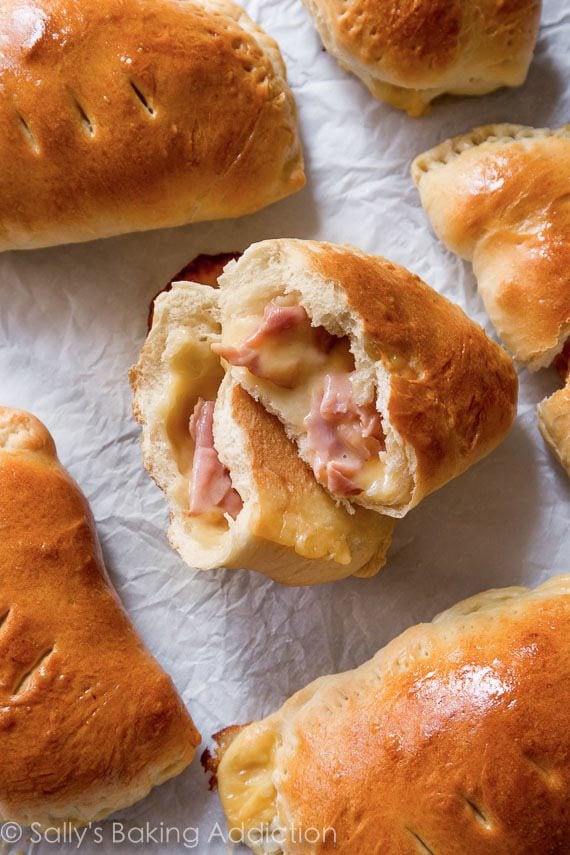 ham and cheese pockets with one pocket cut in half showing ham and cheese filling