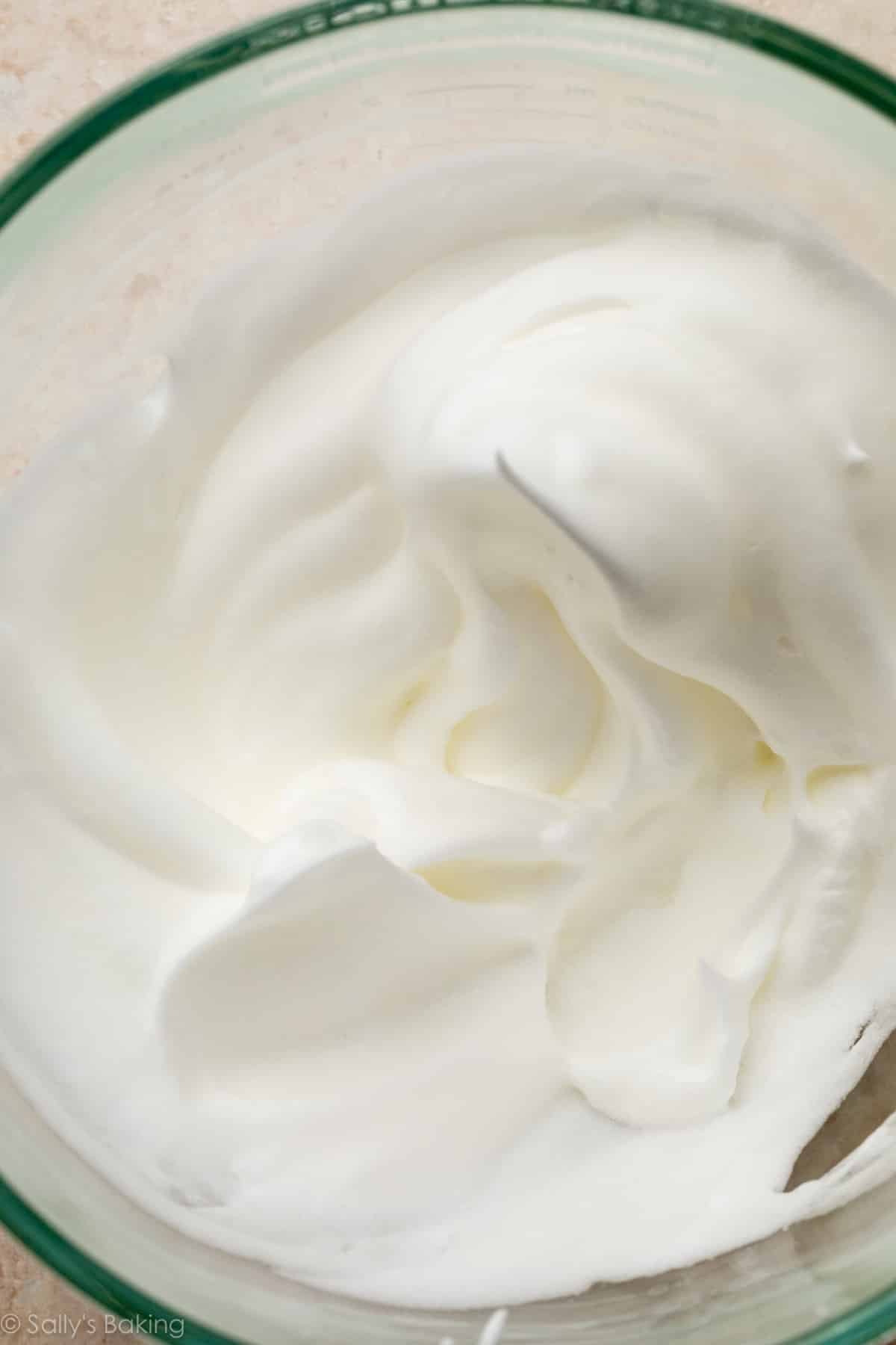 egg whites whipped into stiff peaks in bowl.