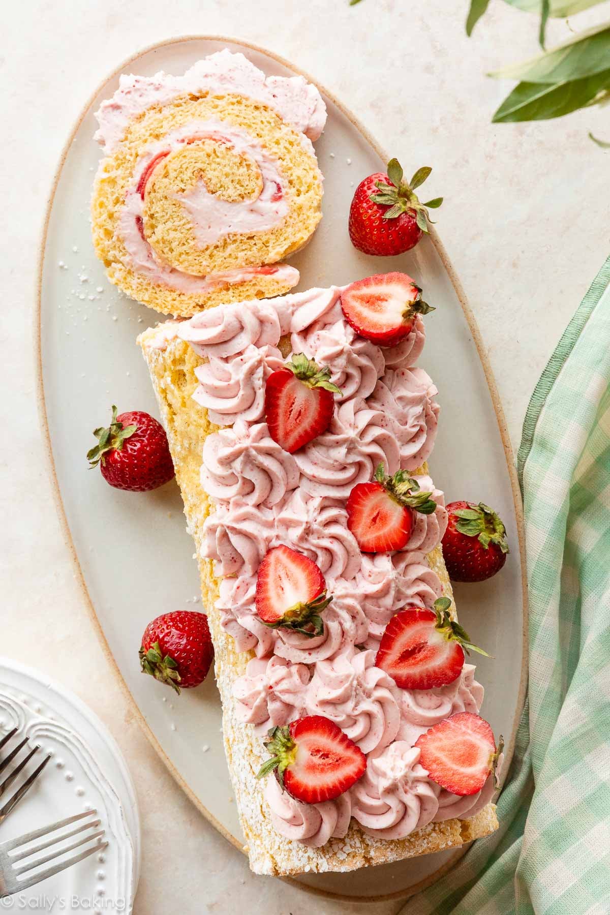 strawberry cake roll with strawberries on top.