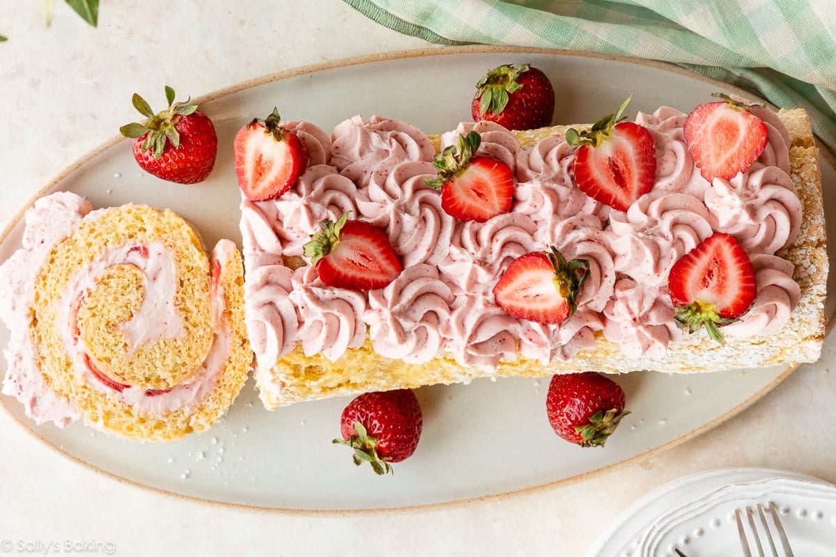strawberry cake roll with strawberries on top.