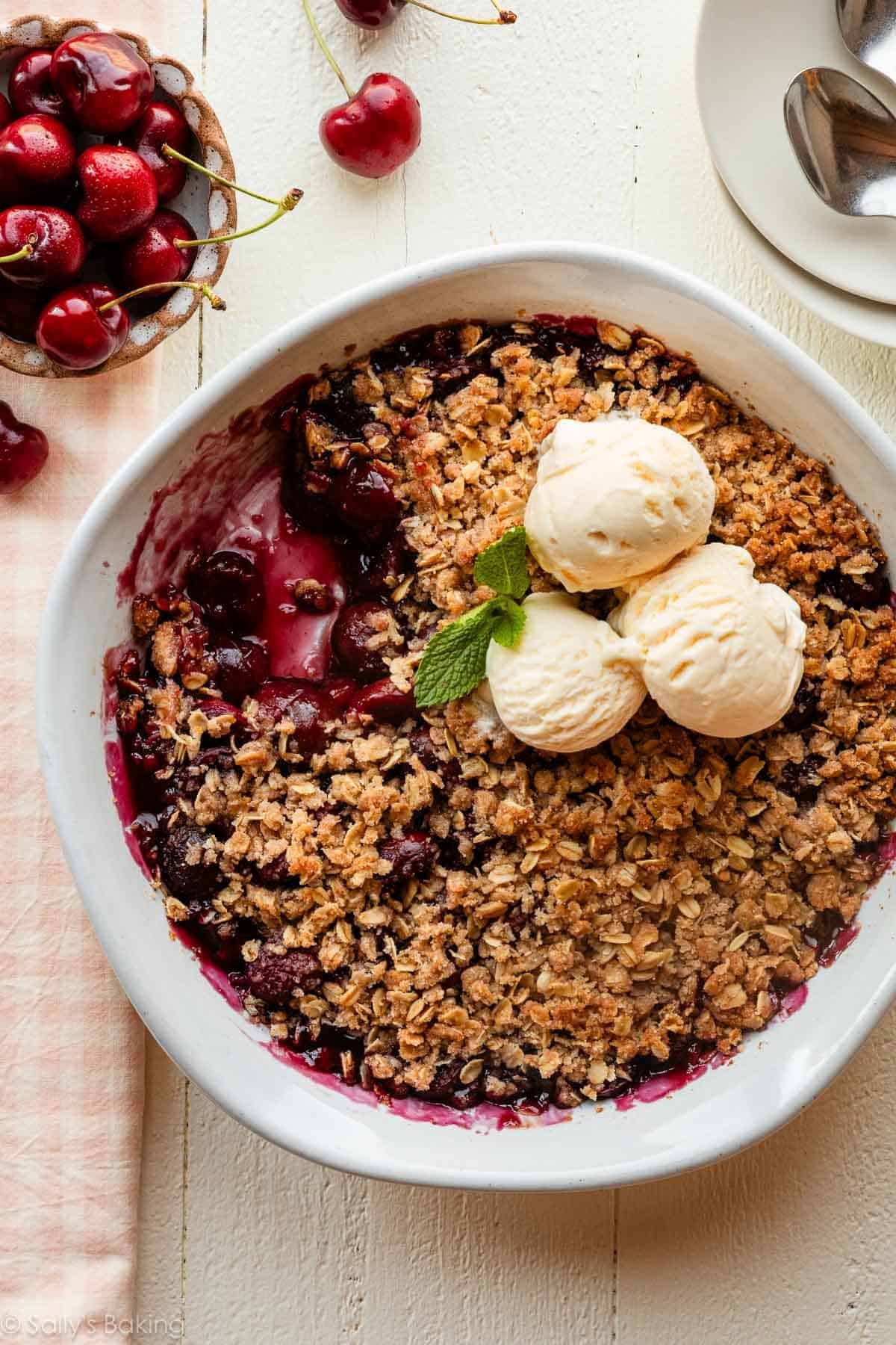 cherry crisp with oatmeal topping and vanilla ice cream.