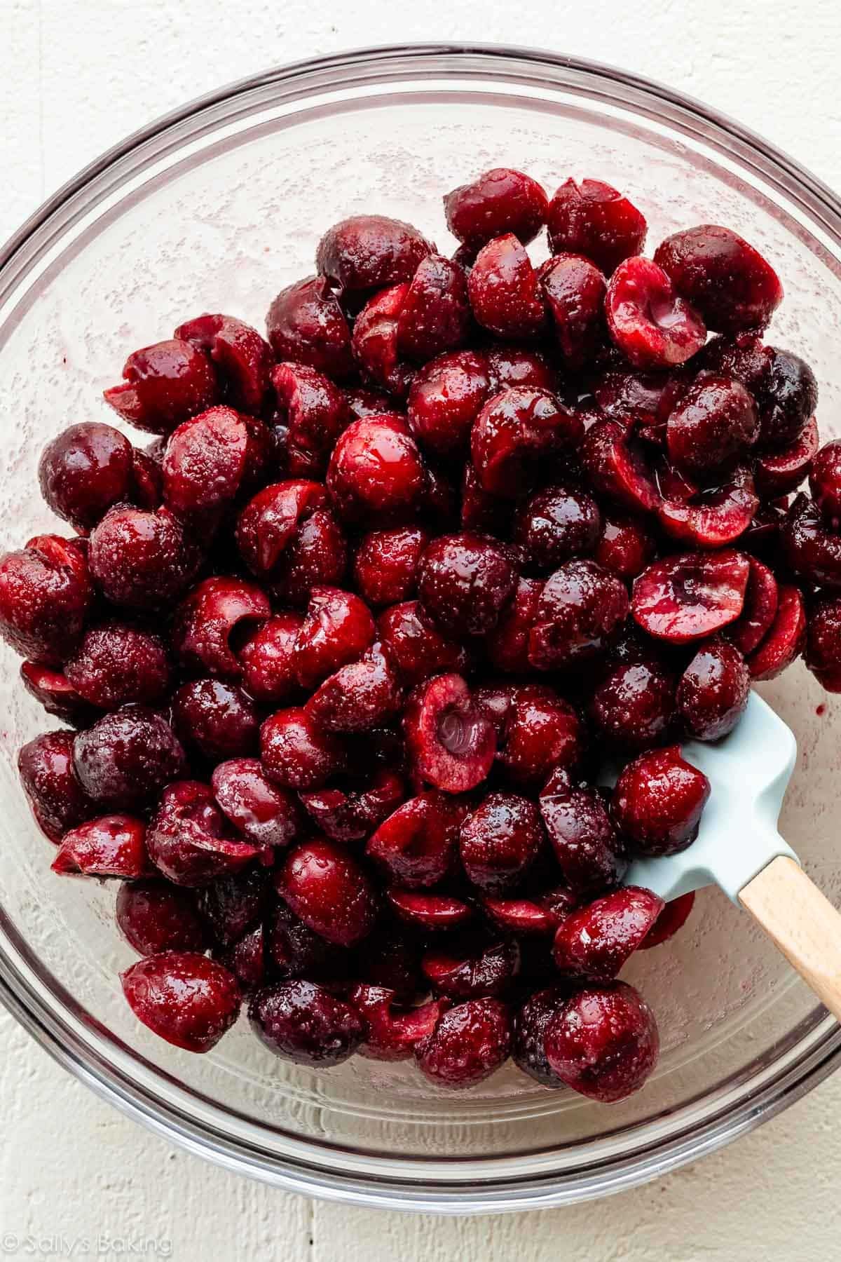 halved cherries in glass bowl.