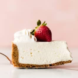 Slice of no bake cheesecake with a strawberry on top