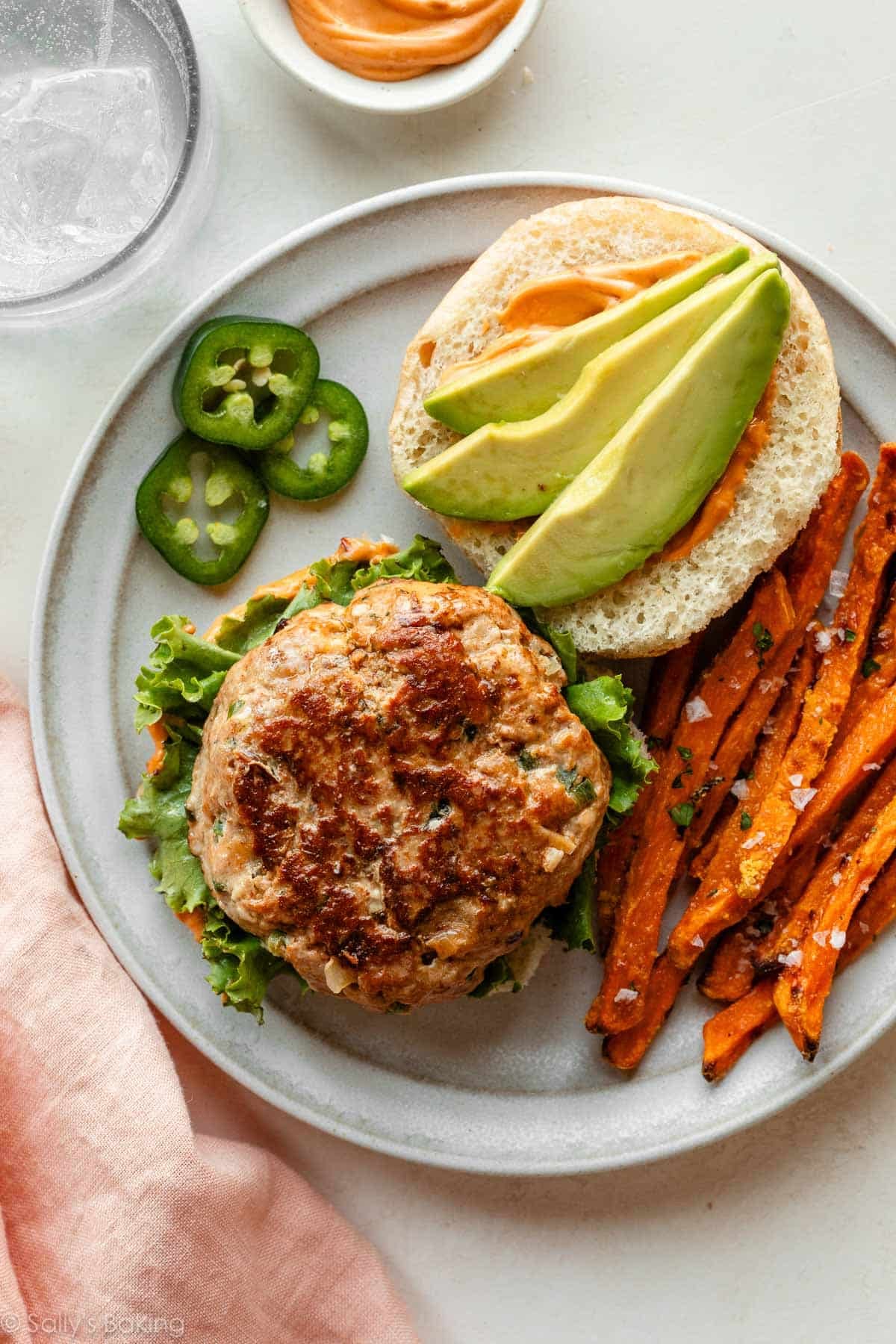 turkey burger on plate with sweet potato fries.