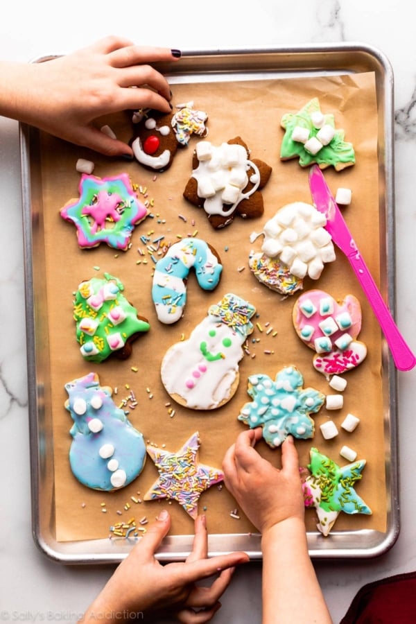 decorated cookies on lined baking sheet