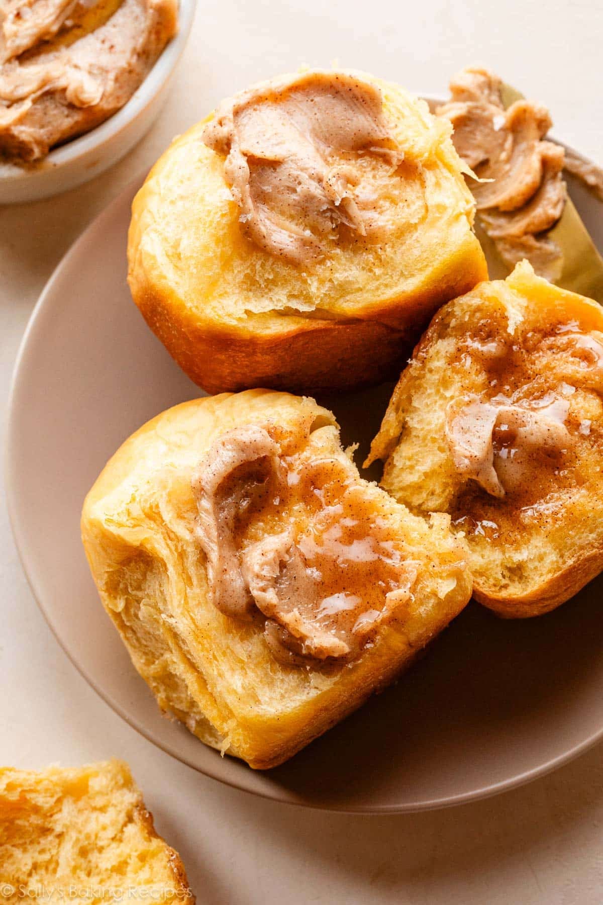 sweet potato rolls with cinnamon butter on beige plate.