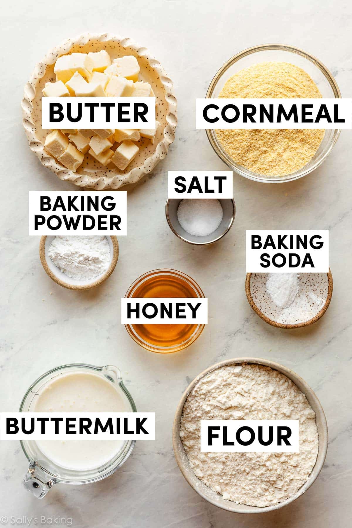ingredients in bowls including cornmeal, flour, buttermilk, honey, and butter.