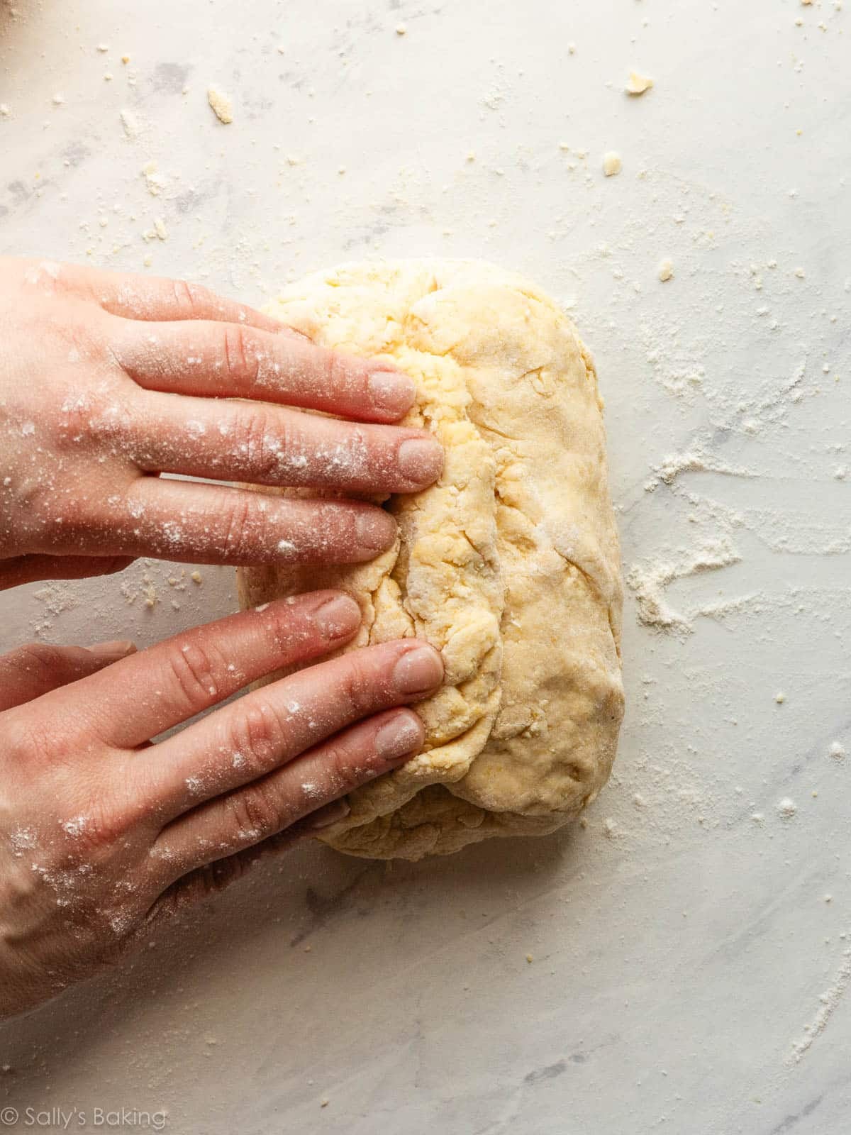 hands folding dough.