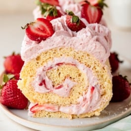 strawberry cake roll with strawberries on top.