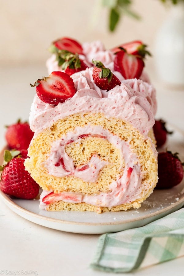 strawberry cake roll with strawberries on top.