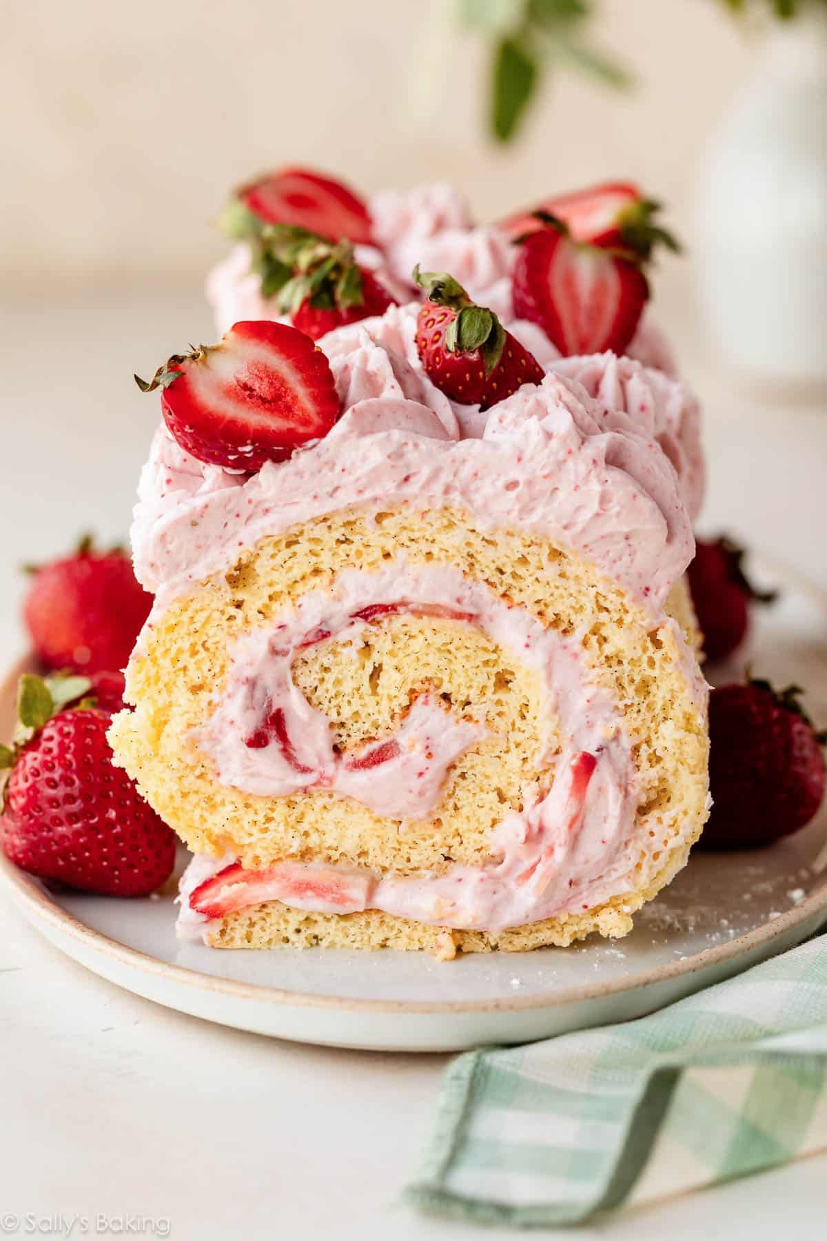 strawberry cake roll with strawberries on top.