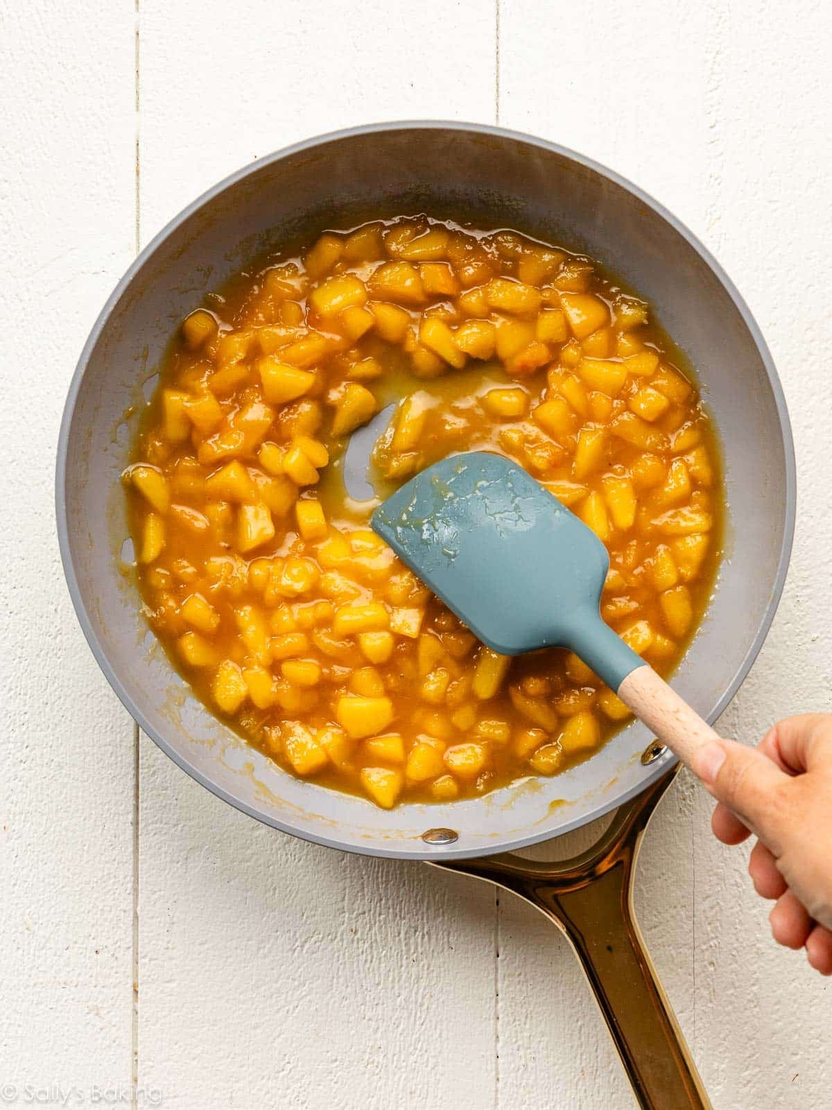 cooked peaches in skillet.