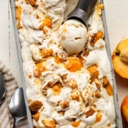 no-churn peach cheesecake ice cream in a loaf pan.