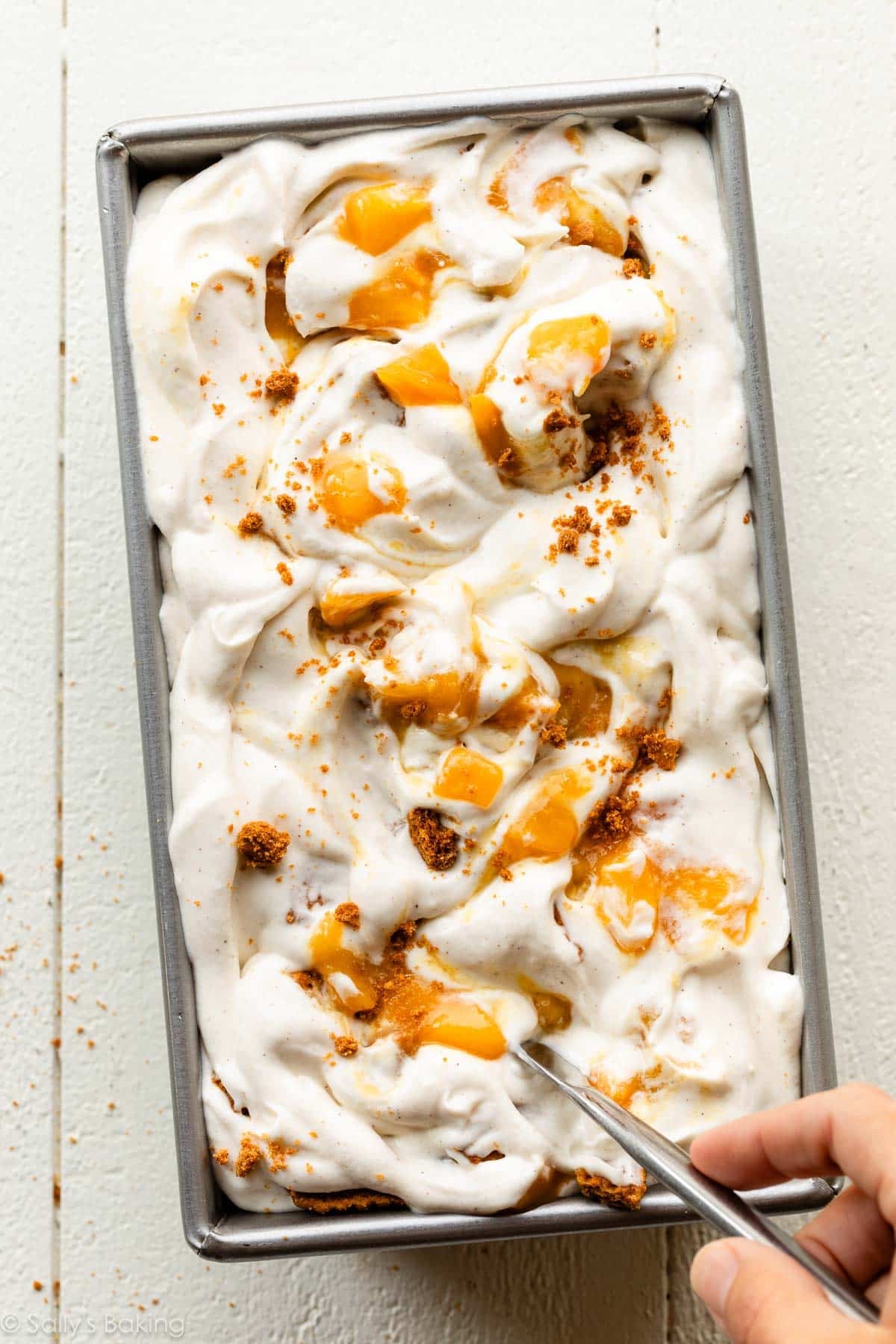 swirling ice cream mixture in pan.