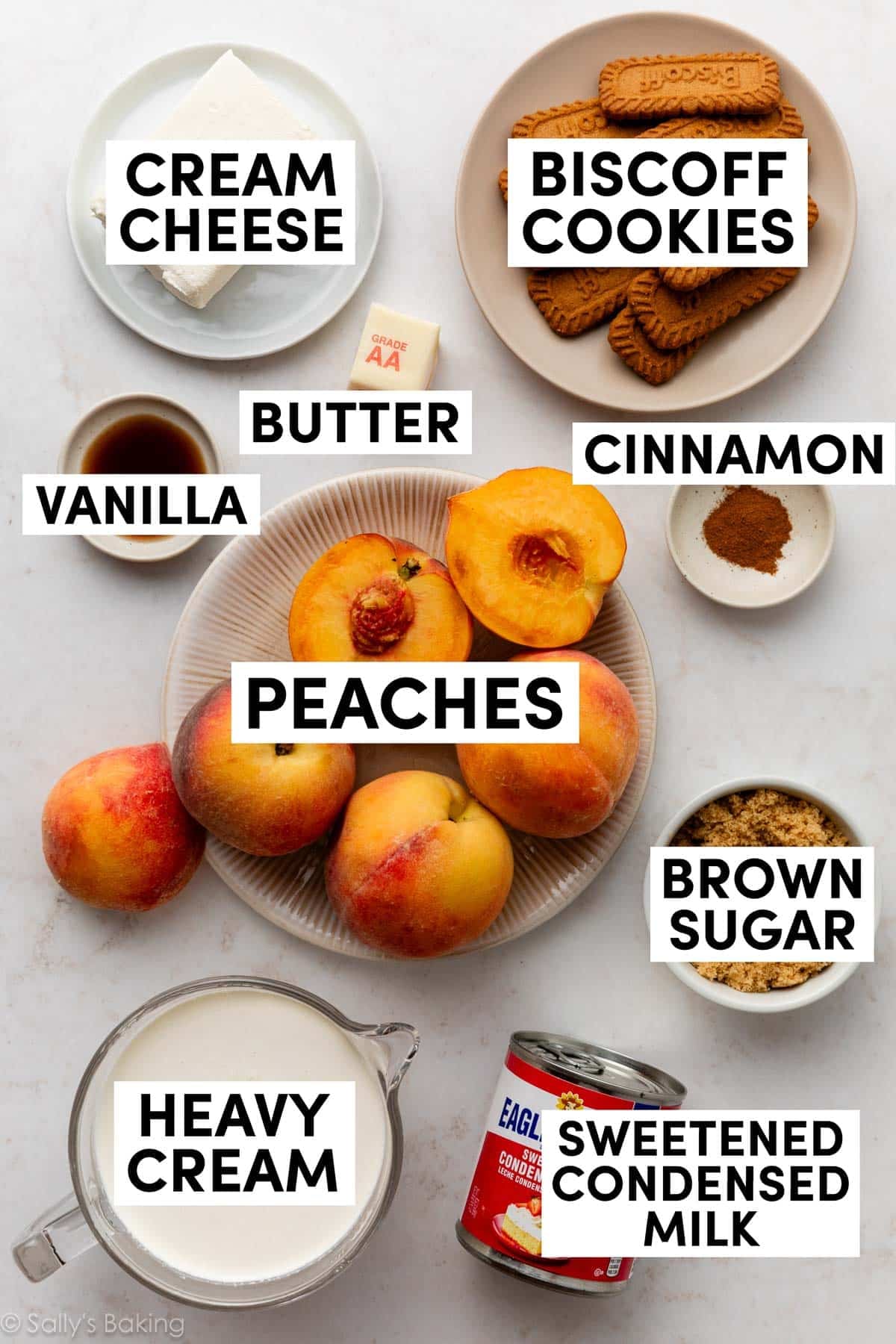 ingredients in bowls and measuring cups including heavy cream, brown sugar, vanilla, cream cheese, and biscoff cookies.