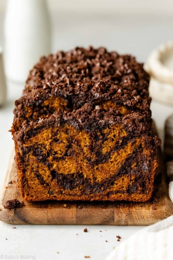 sliced chocolate marble pumpkin bread on a cutting board.